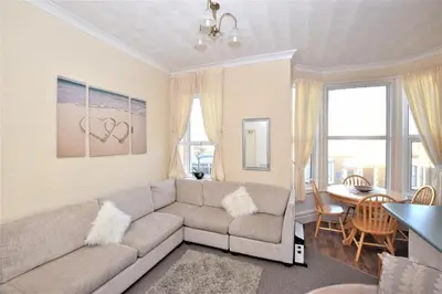a living room with a couch and a table at Bridle Lodge Apartments in Blackpool