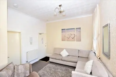 a living room with a couch and a window at Bridle Lodge Apartments in Blackpool