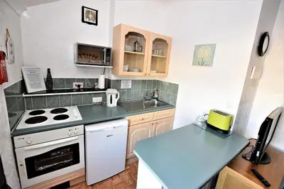 a small kitchen with a stove and a sink at Bridle Lodge Apartments in Blackpool