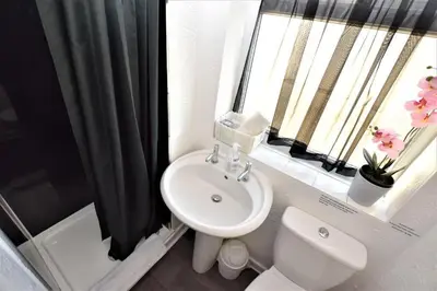 a bathroom with a sink and a toilet and a window at Bridle Lodge Apartments in Blackpool