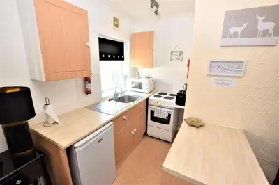 a small kitchen with a sink and a stove at Bridle Lodge Apartments in Blackpool