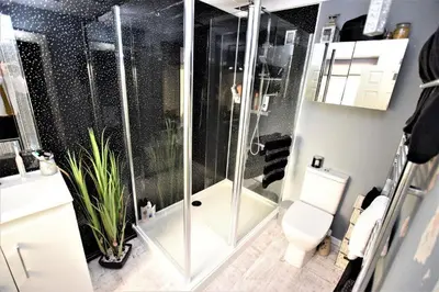 a bathroom with a shower and a toilet at Bridle Lodge Apartments in Blackpool