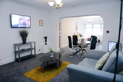 a living room with a couch and a table at Bridle Lodge Apartments in Blackpool