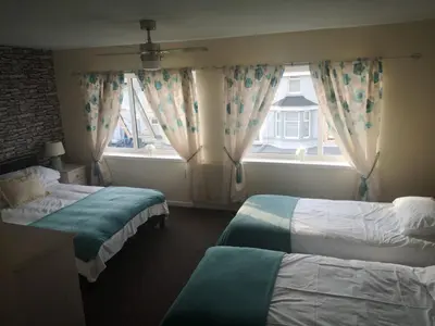 a hotel room with two beds and a window at the belvere in Blackpool