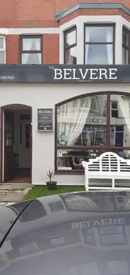 a white bench in front of a store window at the belvere in Blackpool