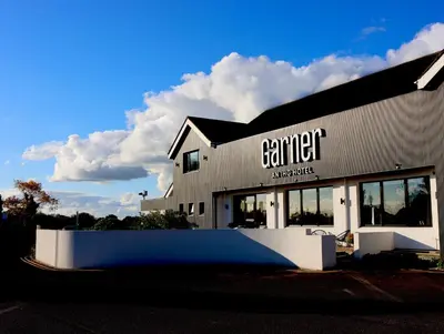 a building with a sign on the side of it at Garner Hotel Preston Samlesbury by IHG in Preston
