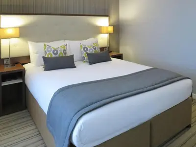 a large white bed in a hotel room at Garner Hotel Preston Samlesbury by IHG in Preston