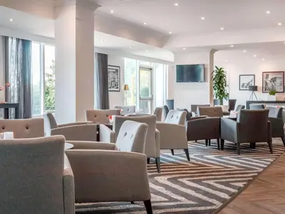 a waiting room with chairs and tables at Garner Hotel Preston Samlesbury by IHG in Preston