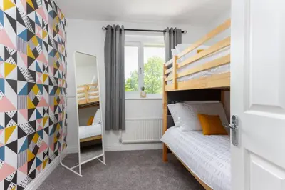 a bedroom with a bunk bed and a mirror at Avella by the Park in Lytham St Annes