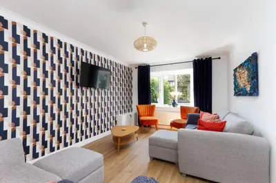 a living room with two couches and a tv at Avella by the Park in Lytham St Annes