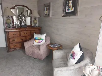 a living room with two chairs and a mirror at Kings Boutique Hotel in Blackpool