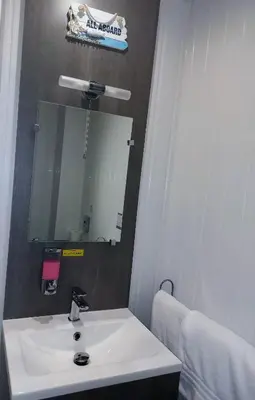 a bathroom with a white sink and a mirror at Kings Boutique Hotel in Blackpool
