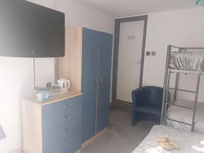 a bedroom with a blue cabinet and a bunk bed at Kings Boutique Hotel in Blackpool
