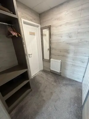 a room with a hallway with wooden walls and a closet at Kings Boutique Hotel in Blackpool