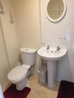 a bathroom with a toilet and a sink at White Moon Hotel in Blackpool