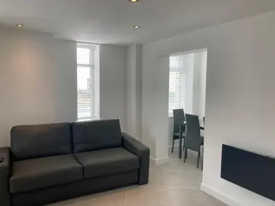 a living room with a couch and a television at Coastal Plaza in Blackpool