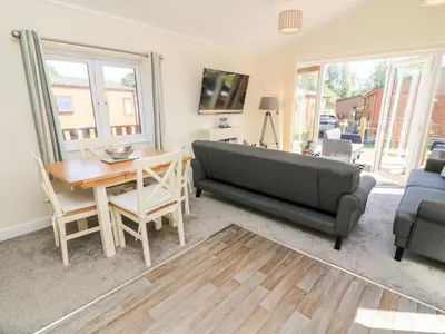 a living room with a couch and a table at Eden Lodge - Sherwood 21 in Carnforth