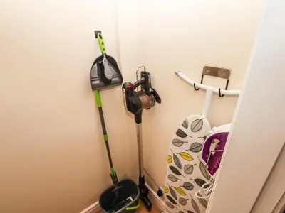 two vacuum cleaners are leaning against a wall at 3 Rothbury Place in Lytham St Annes