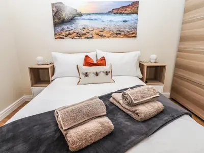 a bedroom with a bed with towels on it at 3 Rothbury Place in Lytham St Annes