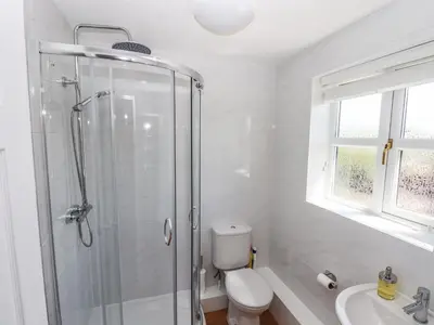a bathroom with a shower and a toilet and a sink at 3 Rothbury Place in Lytham St Annes