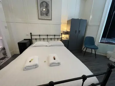 a bedroom with a bed with two towels on it at Elmora House in Blackpool
