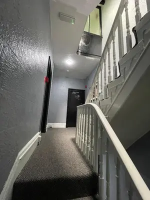 a stairway with a black and white stair case at Elmora House in Blackpool