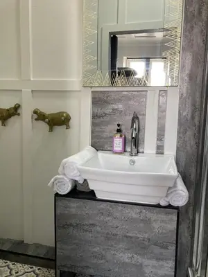 a bathroom with a white sink and a mirror at Elmora House in Blackpool