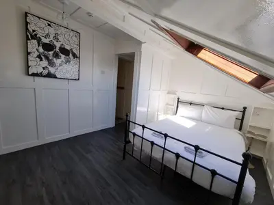 a bedroom with a bed and a painting on the wall at Elmora House in Blackpool