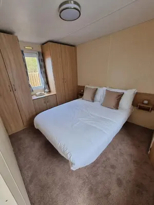a large white bed in a small room at elbry in Heysham