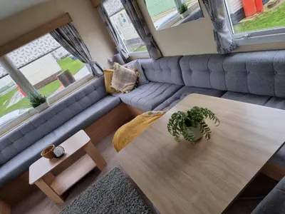 a living room with a table and a couch at elbry in Heysham