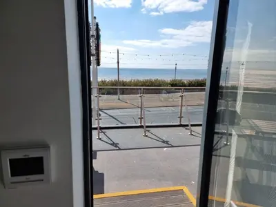 a view of the beach from a window in a room at Granada Apartments Berkeley in Blackpool