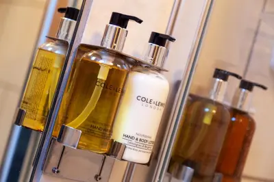 a group of bottles of soap in a shelf at Granada Apartments Berkeley in Blackpool