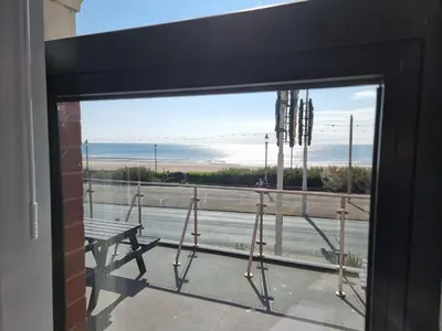a view of the beach from a window at Granada Apartments Berkeley in Blackpool