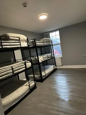 a room with three bunk beds and a window at Brownlows Inn Guest House formerly The King Harry Accommodation in Liverpool