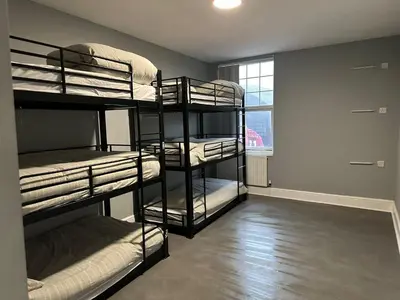 a room with four bunk beds in it with a window at Brownlows Inn Guest House formerly The King Harry Accommodation in Liverpool
