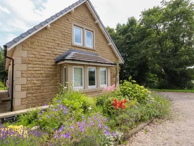 a house with flowers in front of it at Low Orchard House in Preston