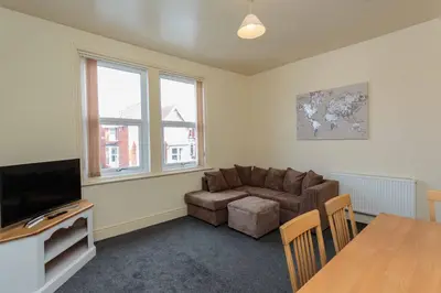 a living room with a couch and a table at Cherry Property - Coconut Suite in Blackpool