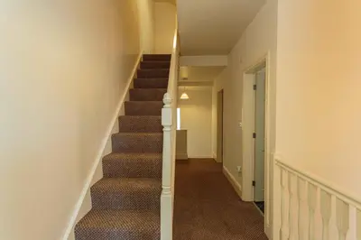 a hallway with a staircase in a house at Cherry Property - Coconut Suite in Blackpool
