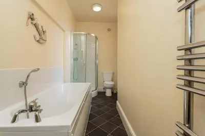 a bathroom with a tub and a toilet at Cherry Property - Coconut Suite in Blackpool