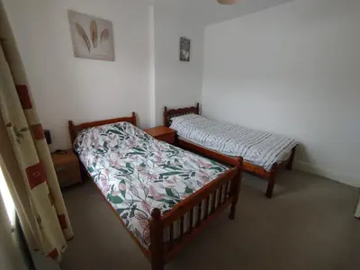 two twin beds in a room with at Cosy end terrace in Lancaster