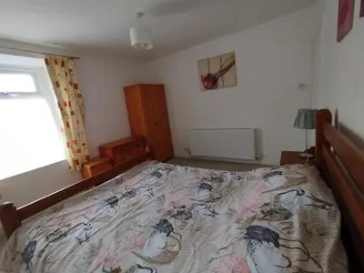 a bedroom with a large bed in a room at Cosy end terrace in Lancaster