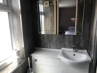 a bathroom with a sink and a mirror at Leecliff Guest House in Blackpool
