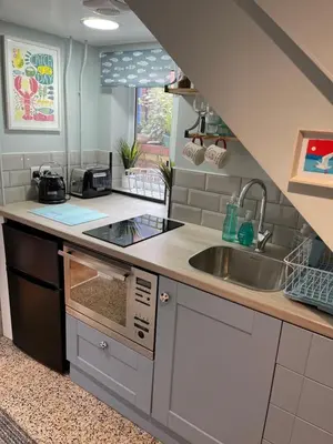 a kitchen with a sink and a counter top at Tiny Beach House in Saint Annes on the Sea