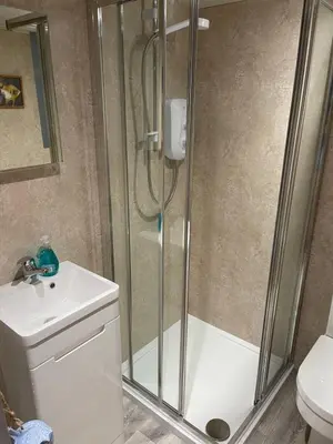 a bathroom with a shower with a sink and a toilet at Tiny Beach House in Saint Annes on the Sea