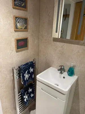 a bathroom with a white sink and a mirror at Tiny Beach House in Saint Annes on the Sea