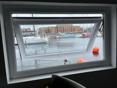 a window with a view of a harbor with boats at Liverpool Waterfront Stay, excellent location , parking available in Liverpool