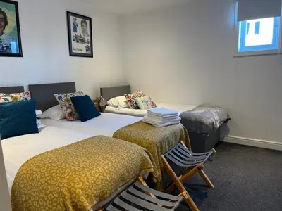a room with two beds and two chairs in it at Liverpool Waterfront Stay, excellent location , parking available in Liverpool