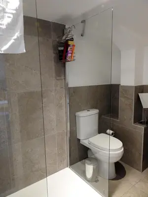 a bathroom with a toilet and a glass shower at Liverpool Waterfront Stay, excellent location , parking available in Liverpool
