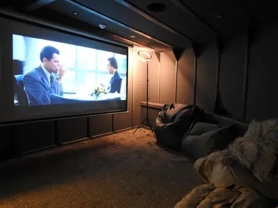 a room with a large television with two men on it at Liverpool Waterfront Stay, excellent location , parking available in Liverpool