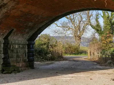 an arch in a brick bridge over a road at 1 Netherbeck Barn in Carnforth